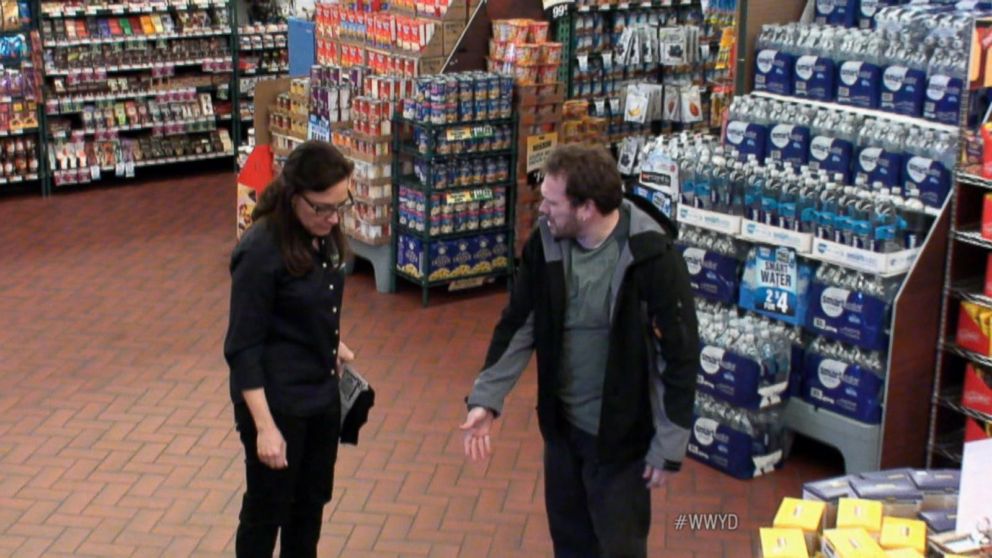 man showing woman spot of slip and fall at a grocery store