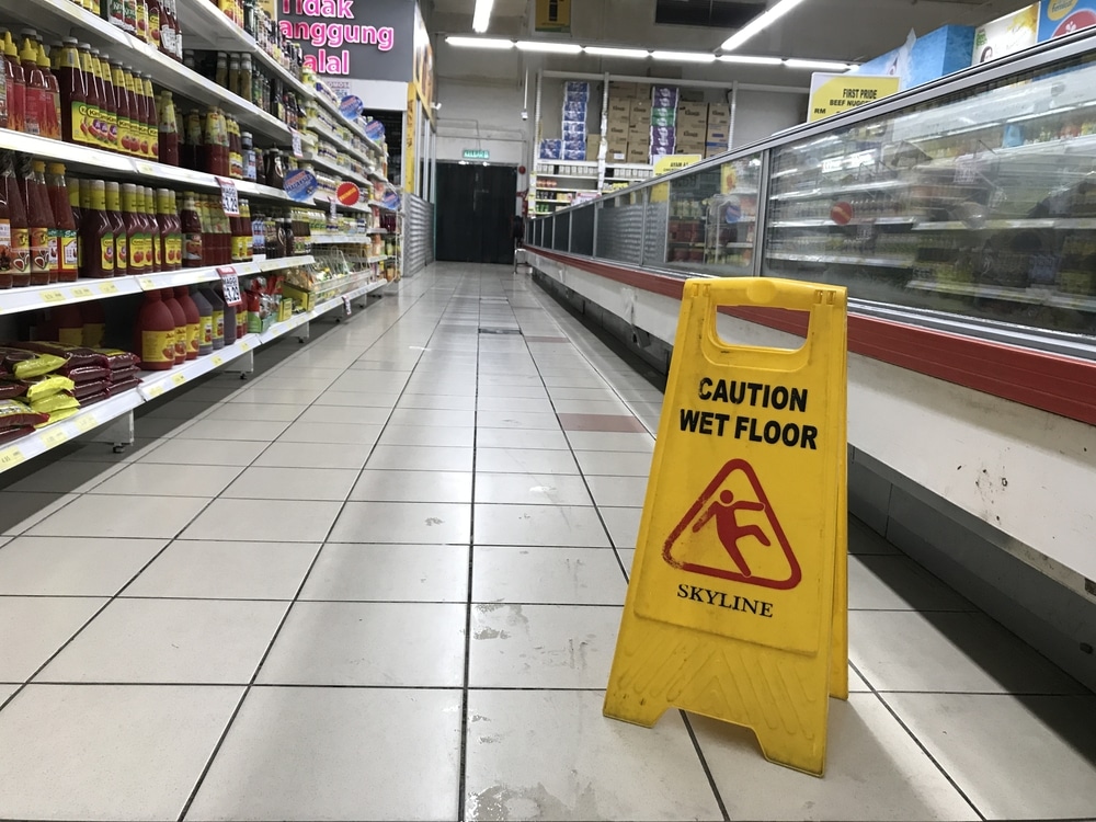 wet floor sign showing slip hazard at grocery store