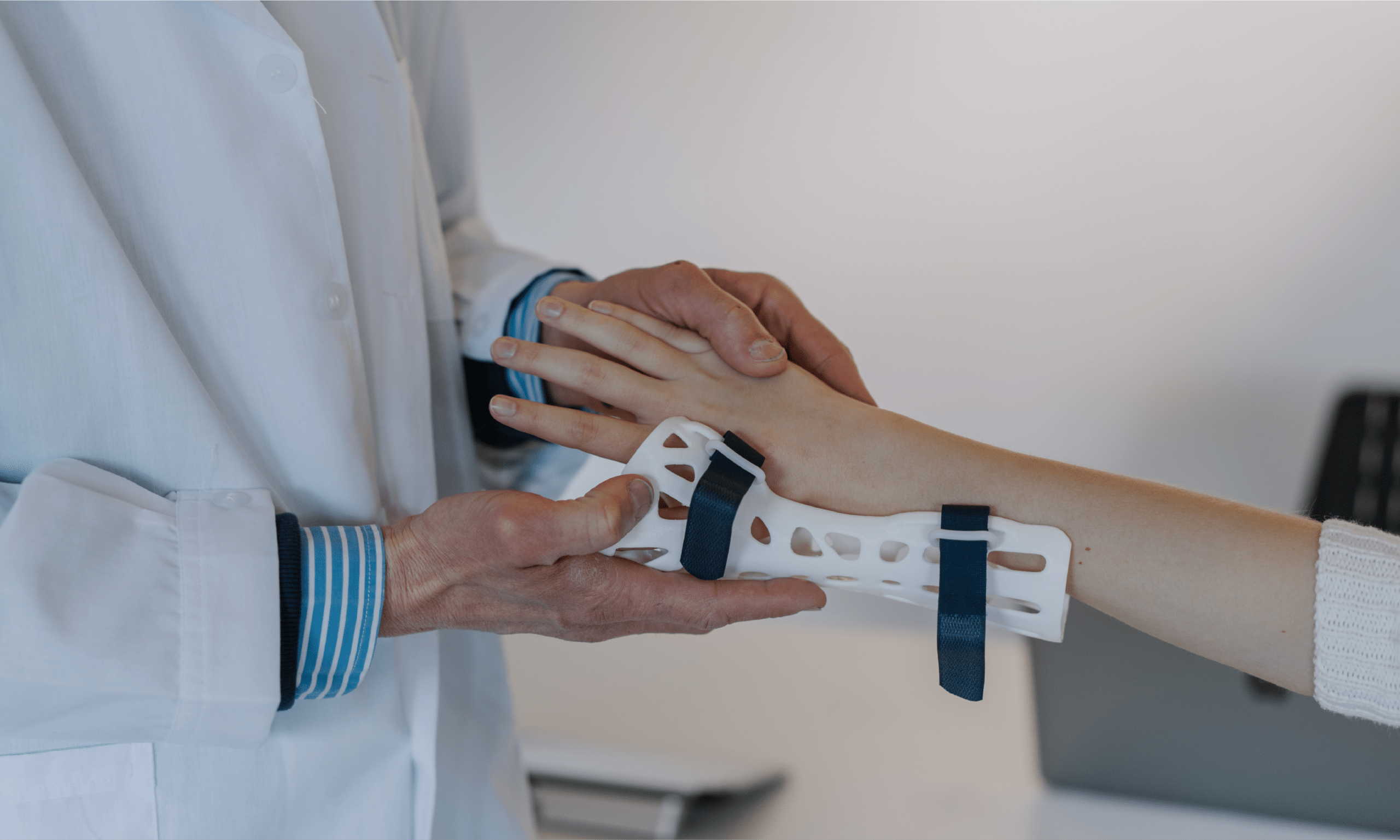 Doctor putting wrist splint on patient after a car accident