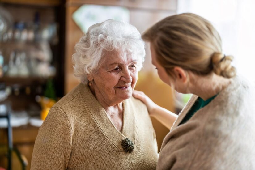 Elderly Woman Talking With A Nursing Home Worker